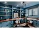 Blue office with built in storage cabinets and desk, along with light wood floors and modern lighting at 111 S Hudson St, Denver, CO 80246