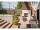 Inviting outdoor patio with fireplace, seating, and lush landscaping provides the perfect space for relaxation at 111 S Hudson St, Denver, CO 80246