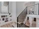 Bright staircase features modern railing, and built-in shelving, providing an open and inviting transition between levels at 111 S Hudson St, Denver, CO 80246