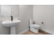 Modern bathroom featuring a pedestal sink, toilet, and white walls at 14283 Currant St, Broomfield, CO 80020