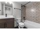 Well-lit bathroom featuring a vanity, toilet, and a tub with patterned tile at 14283 Currant St, Broomfield, CO 80020