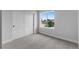 Bright bedroom featuring a large window, neutral carpet, and white sliding closet doors at 14283 Currant St, Broomfield, CO 80020