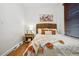 Cozy bedroom featuring a woven headboard, wooden blinds and warm decorative accents at 3911 Navajo St, Denver, CO 80211