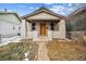 Close-up of an inviting single-story house with a covered front porch and brick supports at 3911 Navajo St, Denver, CO 80211