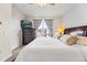 Bedroom with large bed, dark wood furniture, and a bright window at 85 Uinta Way # 603, Denver, CO 80230