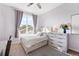 Bedroom features a desk, dresser, bright natural light, area rug, and neutral walls at 85 Uinta Way # 603, Denver, CO 80230