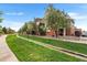 Exterior view of modern townhomes with well-manicured lawns and inviting sidewalk at 85 Uinta Way # 603, Denver, CO 80230