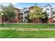 Charming townhouse with brick facade, balcony, and well-maintained front lawn at 85 Uinta Way # 603, Denver, CO 80230