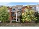 Attractive multi-level townhouse featuring brick and siding with small balconies and lovely trees at 85 Uinta Way # 603, Denver, CO 80230