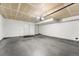 Spacious two car garage with concrete floors and white walls provides ample parking and storage at 85 Uinta Way # 603, Denver, CO 80230