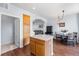 Open kitchen layout with island seating flowing into the dining and living areas at 85 Uinta Way # 603, Denver, CO 80230