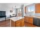 Bright kitchen with wood cabinets, island, and stainless steel appliances at 85 Uinta Way # 603, Denver, CO 80230