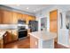 Well-equipped kitchen featuring wood cabinets, stainless steel appliances, and an island at 85 Uinta Way # 603, Denver, CO 80230