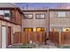 Exterior view of the back of the home with fenced-in yard and patio at 1272 S Crystal Way, Aurora, CO 80012