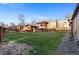 Large grassy backyard with wood fence and row of townhomes at 1272 S Crystal Way, Aurora, CO 80012