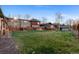 Large grassy backyard with wood fence and row of townhomes at 1272 S Crystal Way, Aurora, CO 80012