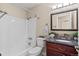 Bathroom featuring a shower, a dark vanity, and great lighting at 1272 S Crystal Way, Aurora, CO 80012