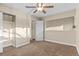 Neutral bedroom with a ceiling fan, closet, and window for natural light at 1272 S Crystal Way, Aurora, CO 80012