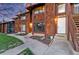 Townhouse with brown wooden shingle siding, red trim, and an inviting front entrance at 1272 S Crystal Way, Aurora, CO 80012
