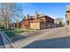 Exterior view showcasing the townhomes, featuring a garage, private balconies, and well-maintained landscaping at 1272 S Crystal Way, Aurora, CO 80012