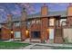 Charming townhouse exterior with wood facade, inviting entrance, and well-maintained landscaping at 1272 S Crystal Way, Aurora, CO 80012