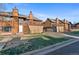 A front exterior view of townhomes, featuring private balconies and well-maintained landscaping at 1272 S Crystal Way, Aurora, CO 80012