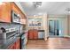 Updated kitchen boasts modern appliances, granite countertops, and stylish wooden cabinets at 1272 S Crystal Way, Aurora, CO 80012