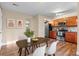 The kitchen features wooden cabinets, stainless steel appliances, and a dining area, perfect for modern living at 1272 S Crystal Way, Aurora, CO 80012