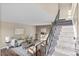 Comfortable living area with stylish furniture, a patterned rug, and a staircase at 1272 S Crystal Way, Aurora, CO 80012