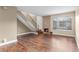Bright living room with hardwood floors, a stone fireplace, and a staircase at 1272 S Crystal Way, Aurora, CO 80012