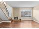 Living room featuring a stone fireplace, staircase, hardwood floors, and natural light at 1272 S Crystal Way, Aurora, CO 80012
