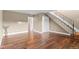 Spacious living room featuring wood flooring, staircase, and neutral paint at 1272 S Crystal Way, Aurora, CO 80012