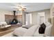 Main bedroom boasts a cozy brick fireplace, ceiling fan, and ample closet space at 1272 S Crystal Way, Aurora, CO 80012