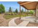 Backyard featuring a covered porch, mature landscaping, and a walking path at 23993 E Briarwood Dr, Aurora, CO 80016