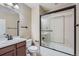 Bathroom features a shower with sliding glass doors, updated fixtures and tile flooring at 23993 E Briarwood Dr, Aurora, CO 80016