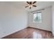 This bedroom has hardwood floors, a ceiling fan and a large window for natural light at 23993 E Briarwood Dr, Aurora, CO 80016