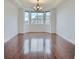 Bright dining room features a bay window and crown molding with gorgeous hardwood floors at 23993 E Briarwood Dr, Aurora, CO 80016
