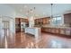Spacious kitchen boasts a large center island, stainless steel appliances and custom cabinets at 23993 E Briarwood Dr, Aurora, CO 80016