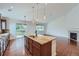 Gourmet kitchen features a central island, stainless steel appliances, and opens to a large living space at 23993 E Briarwood Dr, Aurora, CO 80016