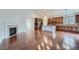 Open concept living space with hardwood floors, fireplace, and kitchen with stainless steel appliances at 23993 E Briarwood Dr, Aurora, CO 80016
