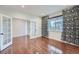 Home office features glass French doors, hardwood floors, and a large window with modern window treatments at 23993 E Briarwood Dr, Aurora, CO 80016
