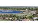 Overhead view of serene lake and neighborhood, trails wind through lush greenery and trees at 12604 Madison Way, Thornton, CO 80241