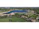Scenic aerial view of the community, showcasing a beautiful lake, walking paths, and green spaces at 12604 Madison Way, Thornton, CO 80241