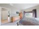 Bright bedroom featuring natural wood furniture and a large window with great natural light at 12604 Madison Way, Thornton, CO 80241