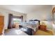 Primary bedroom featuring a large window, dark wood furniture, and plush bedding at 12604 Madison Way, Thornton, CO 80241