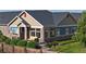 Charming home featuring stone accents, tan siding, and a cozy front porch with a seating area at 12604 Madison Way, Thornton, CO 80241