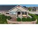 Attractive single-Gathering home featuring a stone facade, manicured landscaping, and a charming front porch at 12604 Madison Way, Thornton, CO 80241