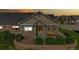 Inviting single-Gathering home featuring a stone facade, well-kept landscaping, and a welcoming front porch at 12604 Madison Way, Thornton, CO 80241