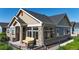Attractive home featuring a welcoming front porch, stone accents, and mature landscaping at 12604 Madison Way, Thornton, CO 80241