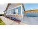 Exterior shot displaying stone detailing, blue siding, and a large garage with plentiful parking at 12604 Madison Way, Thornton, CO 80241